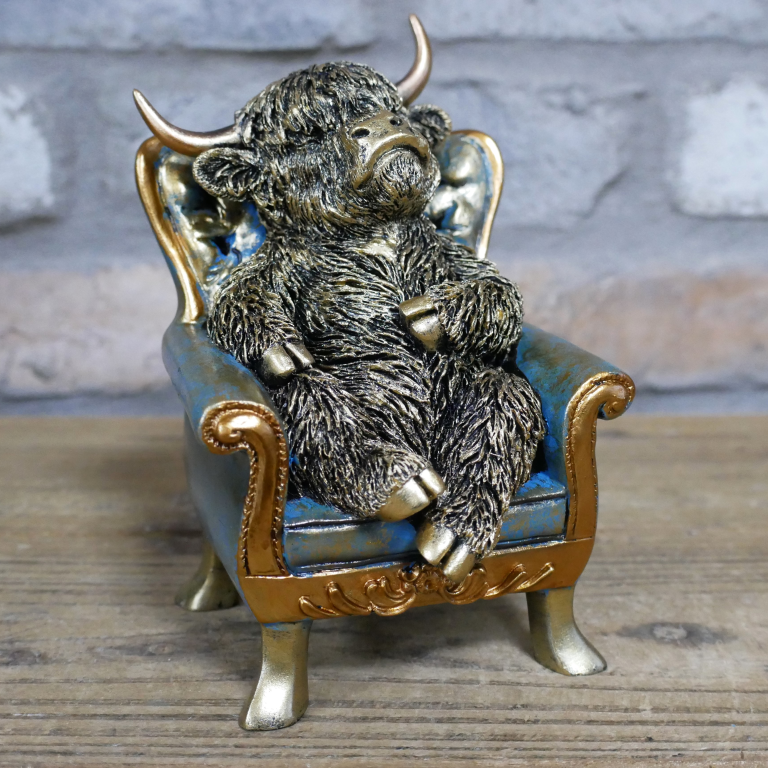 Small Highland Cow On A Chair
