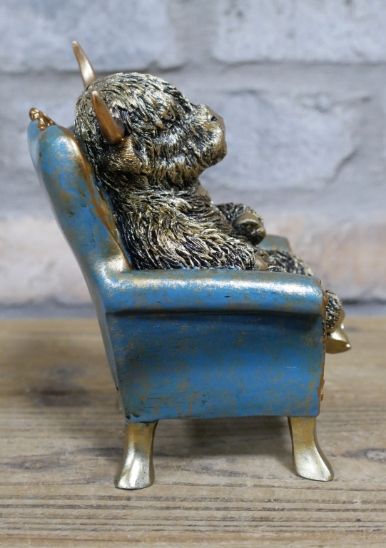 Small Highland Cow On A Chair