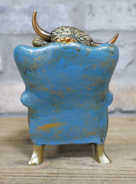Small Highland Cow On A Chair