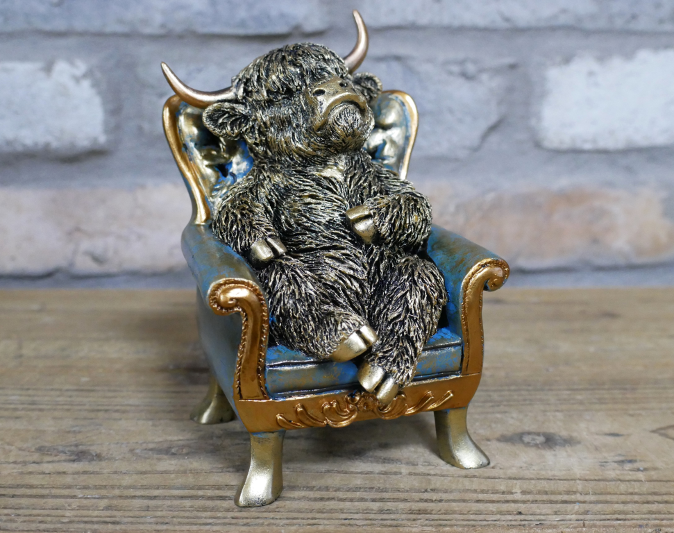 Small Highland Cow On A Chair