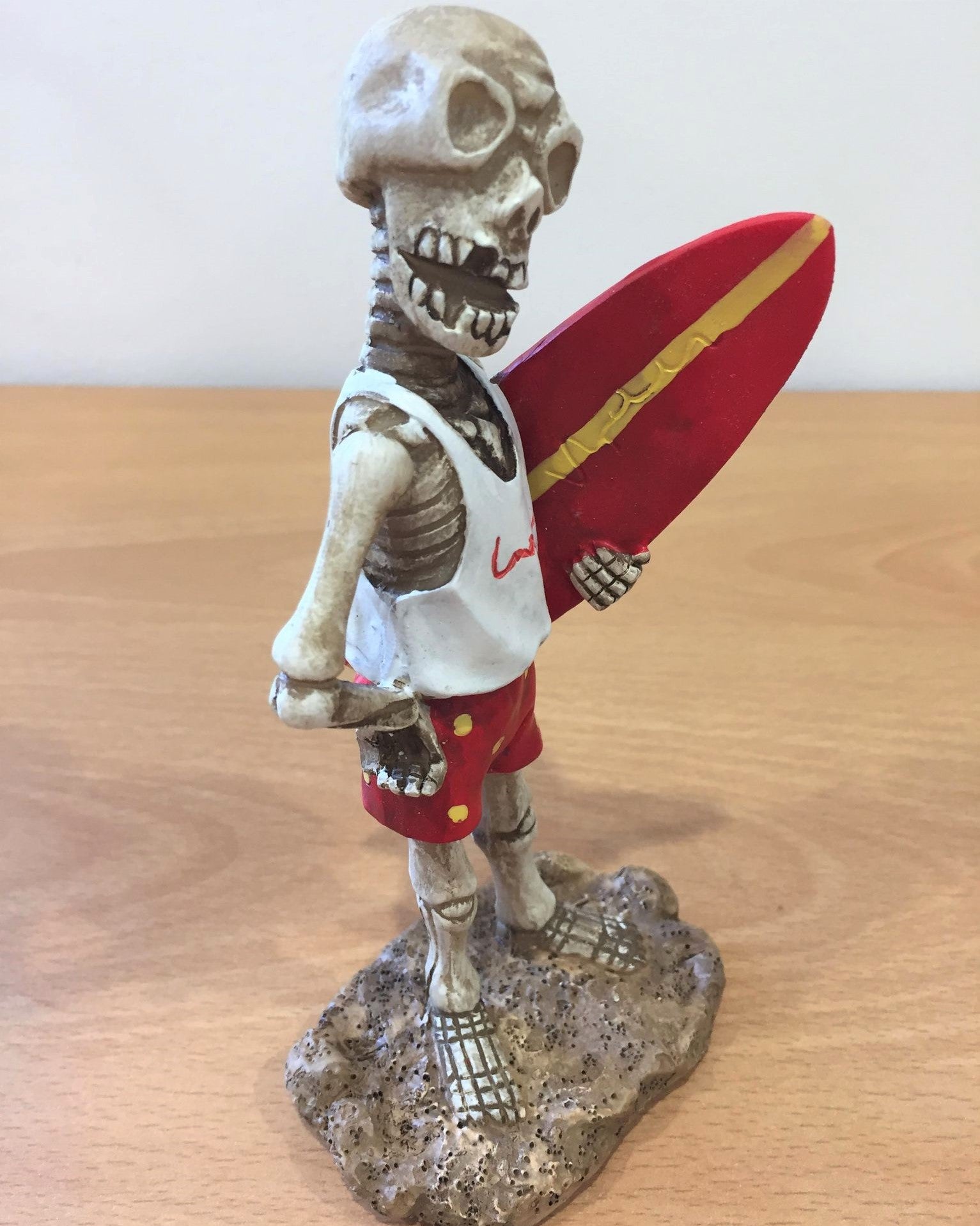 Skeleton Holding Surfboard