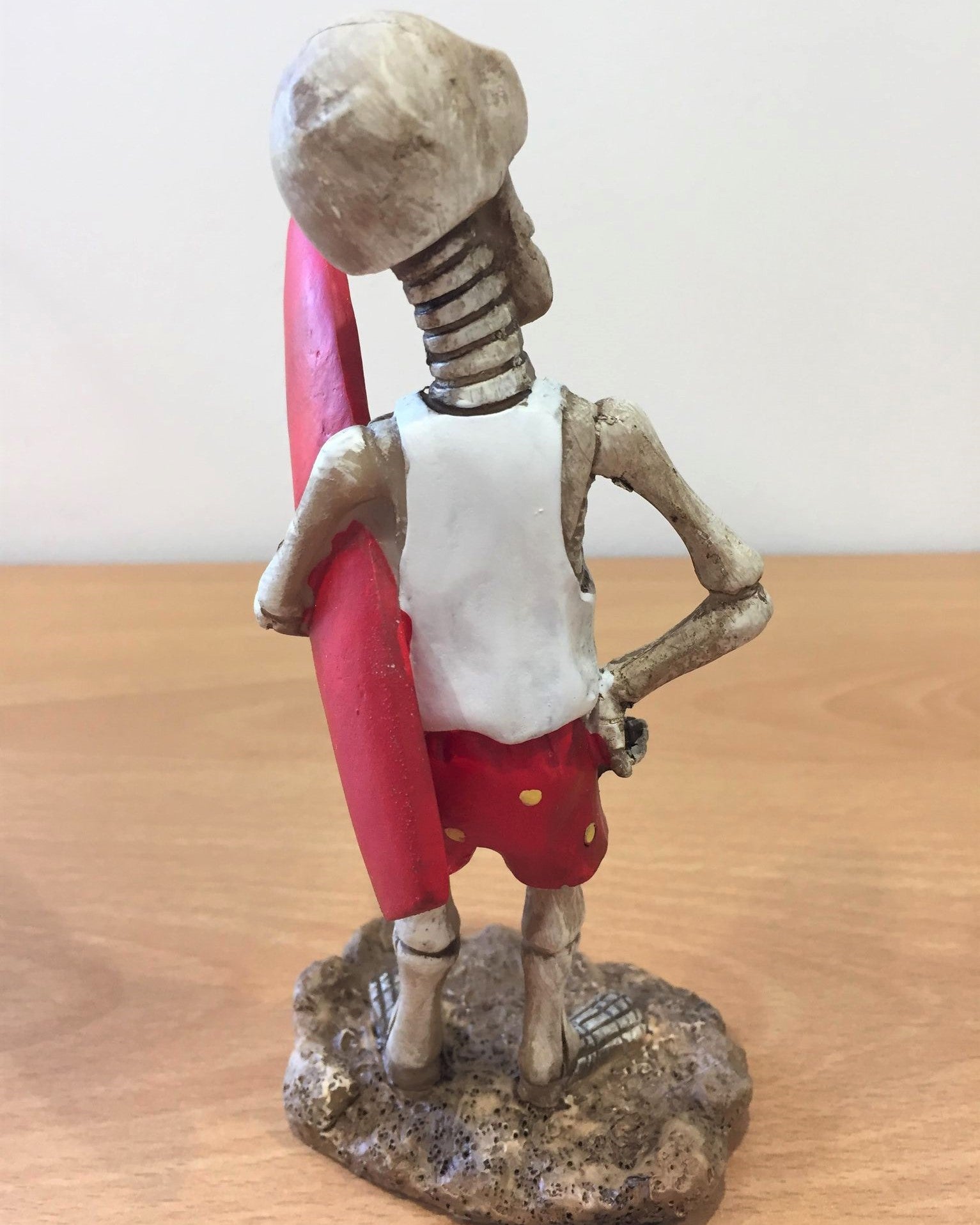 Skeleton Holding Surfboard