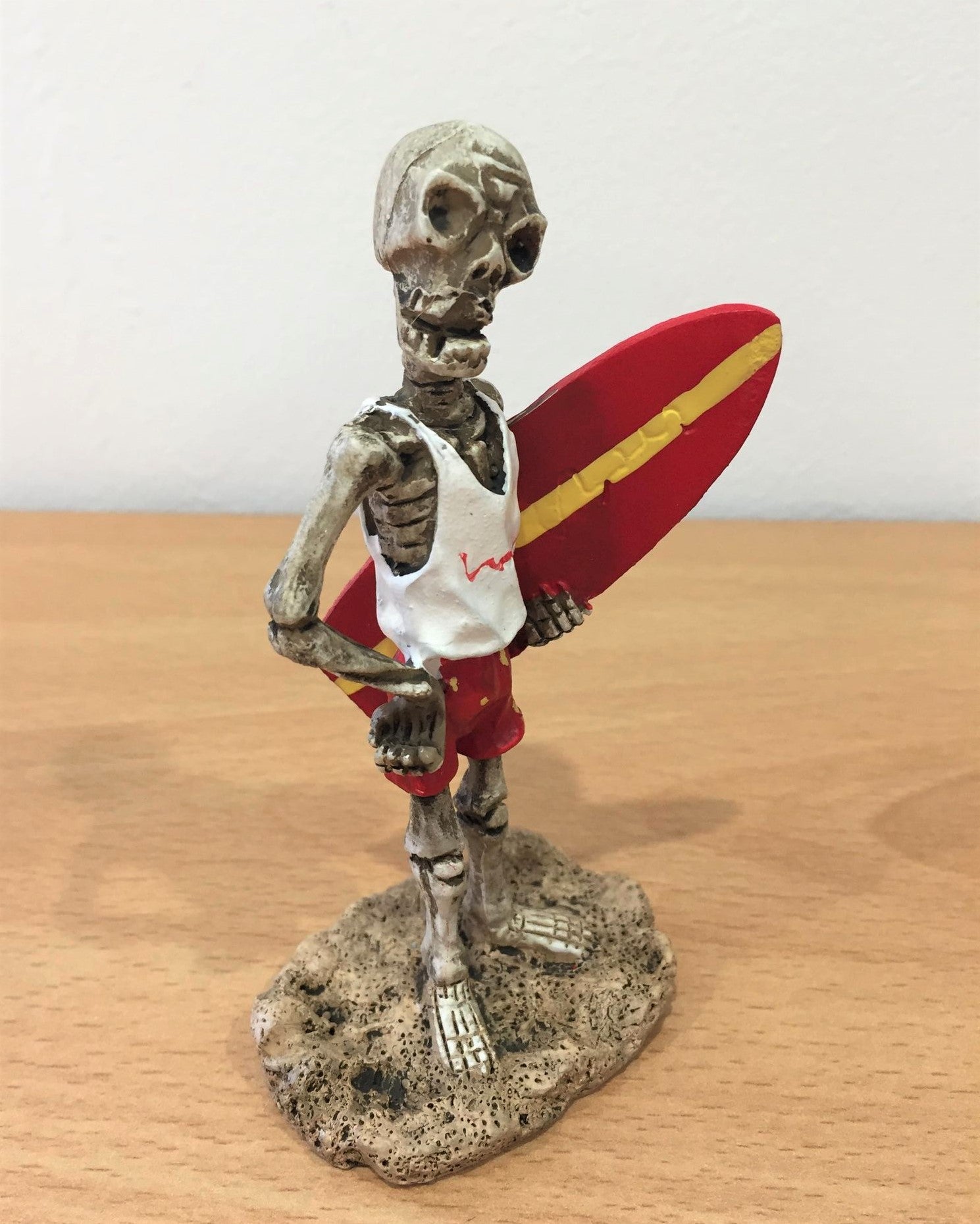 Skeleton Holding Surfboard