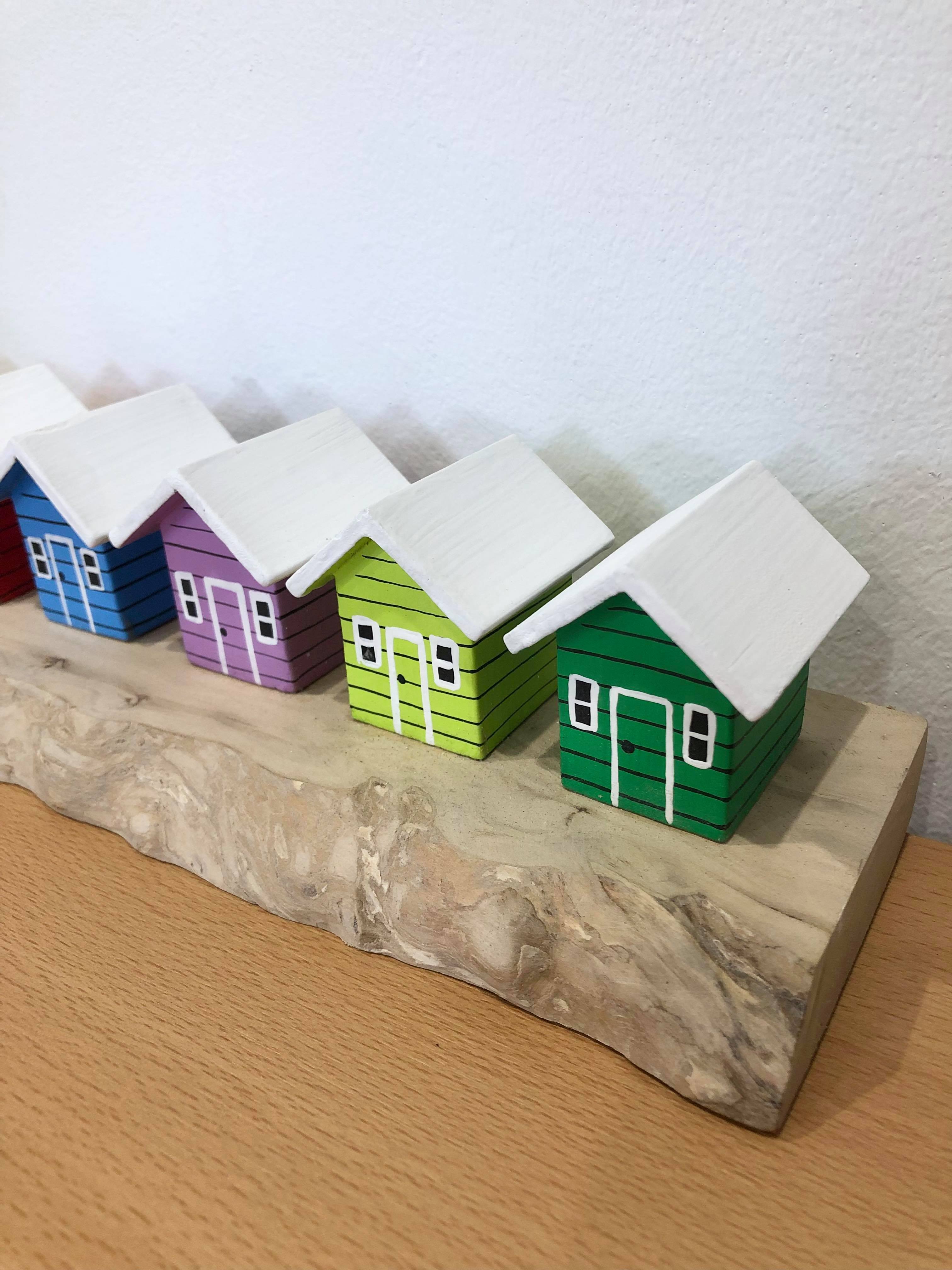 Coloured Beach Houses On Carved Light Brown Wood