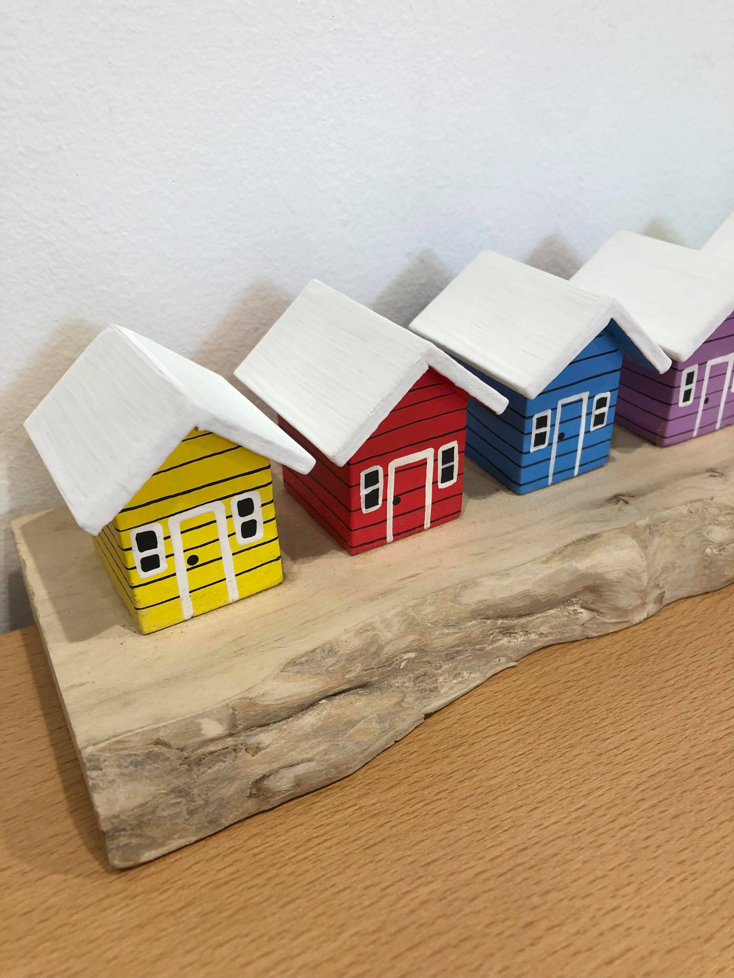 Coloured Beach Houses On Carved Light Brown Wood