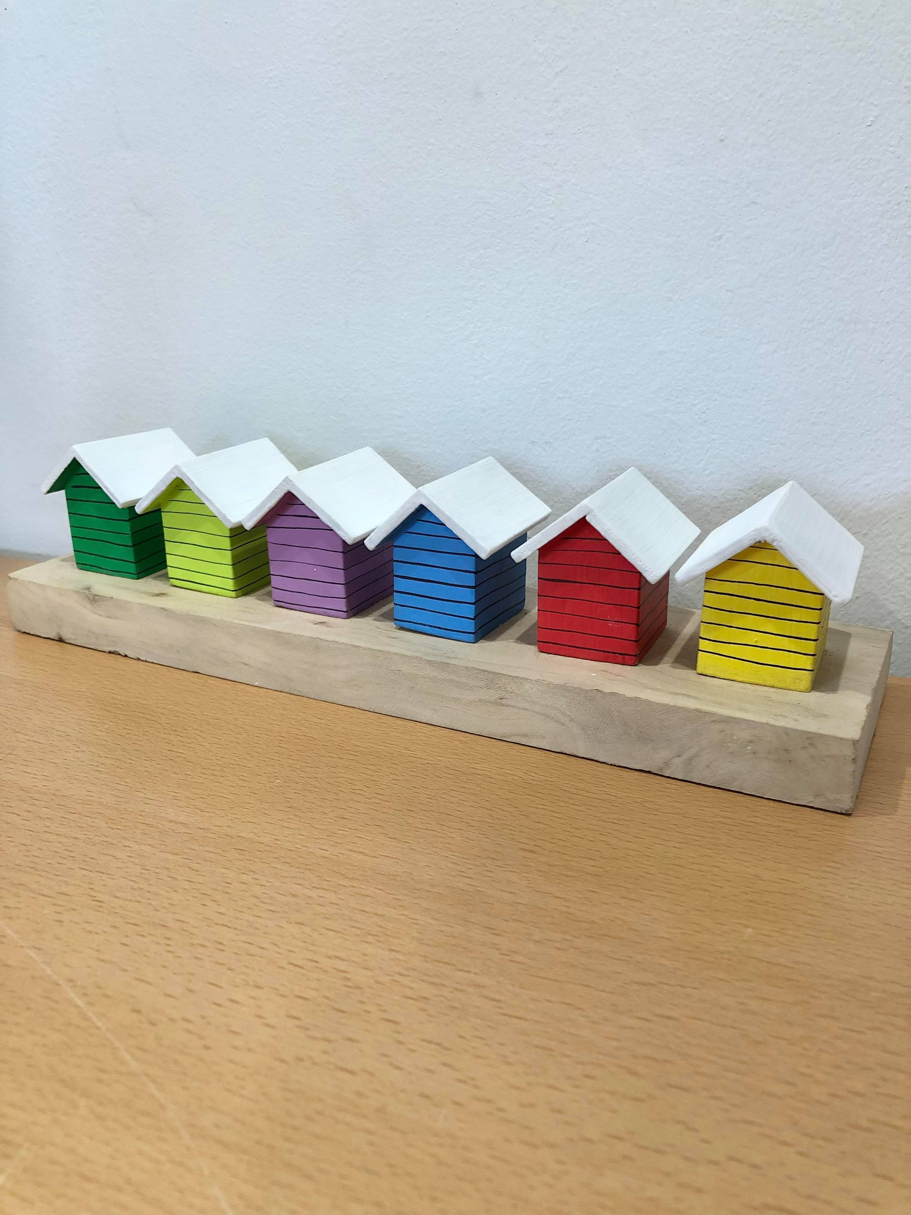 Coloured Beach Houses On Carved Light Brown Wood