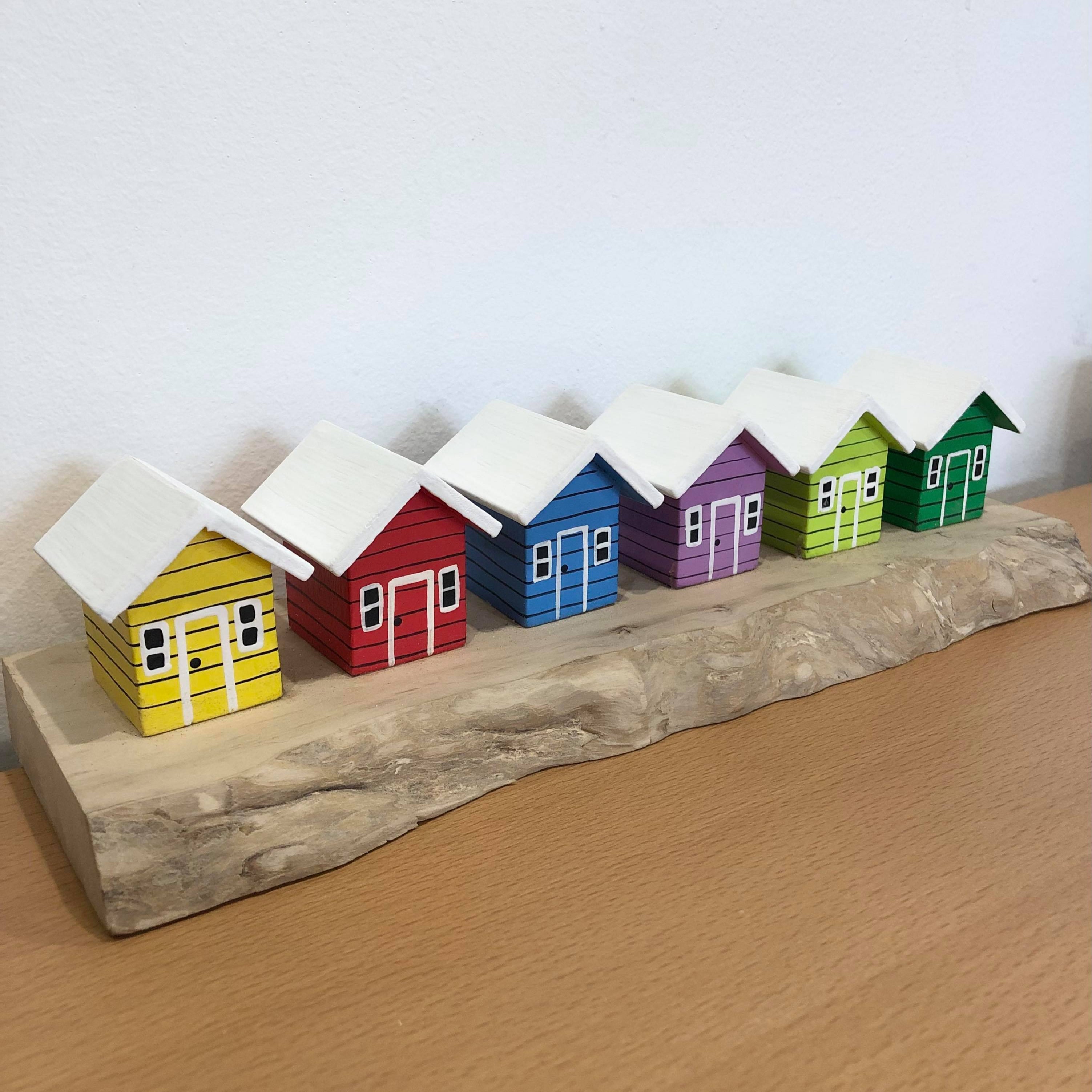Coloured Beach Houses On Carved Light Brown Wood