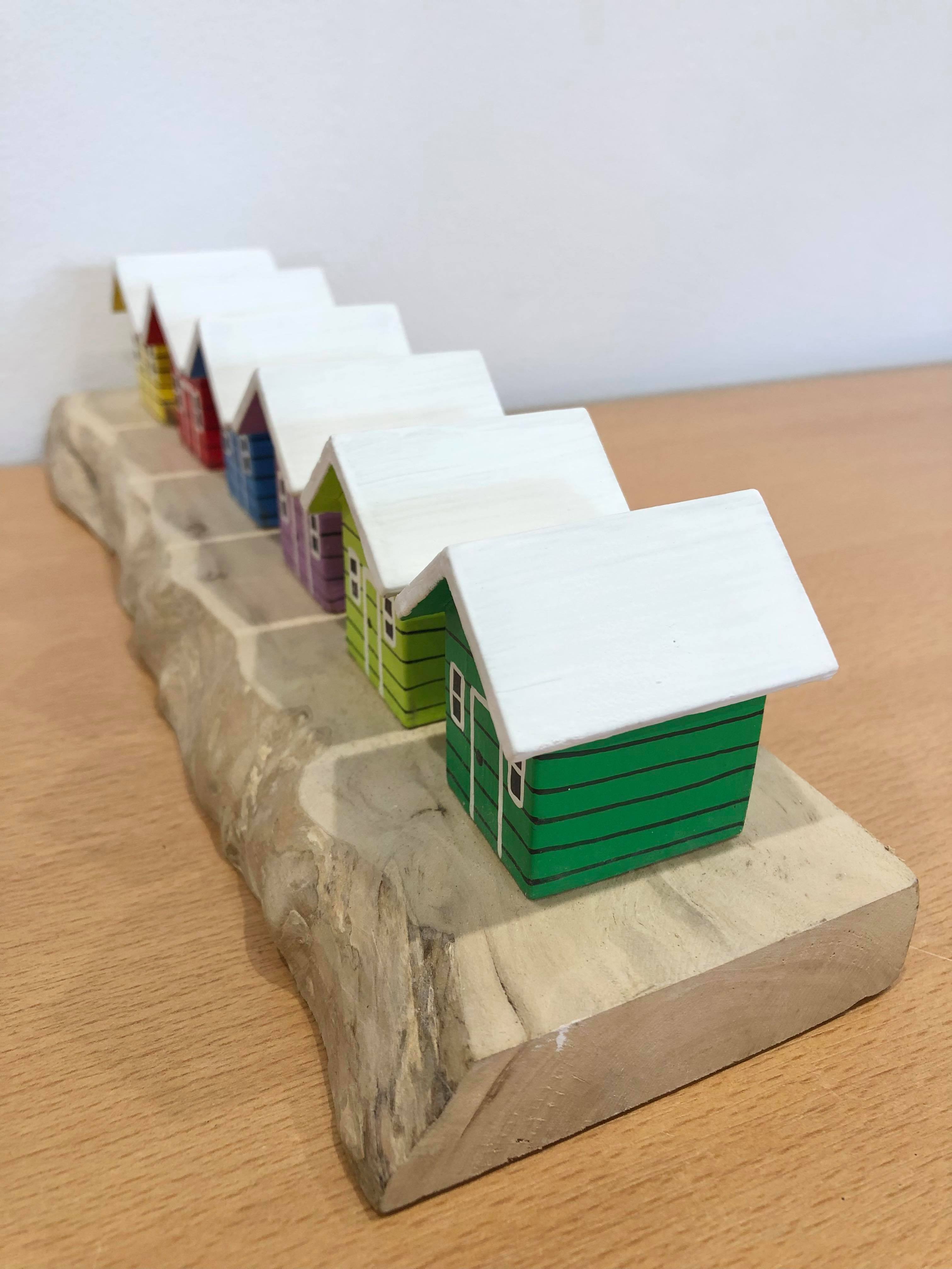 Coloured Beach Houses On Carved Light Brown Wood