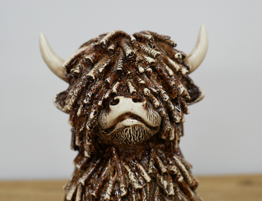 Small Sitting Highland Cow