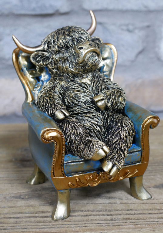 Small Highland Cow On A Chair