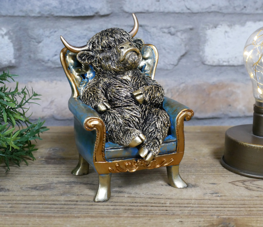 Small Highland Cow On A Chair