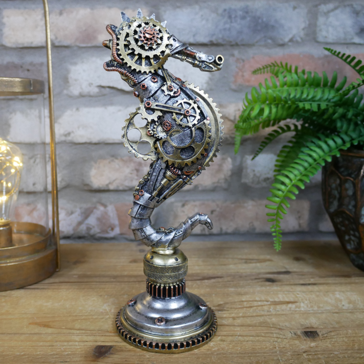Decorative seahorse sculpture with gears on a wooden surface, brick wall background